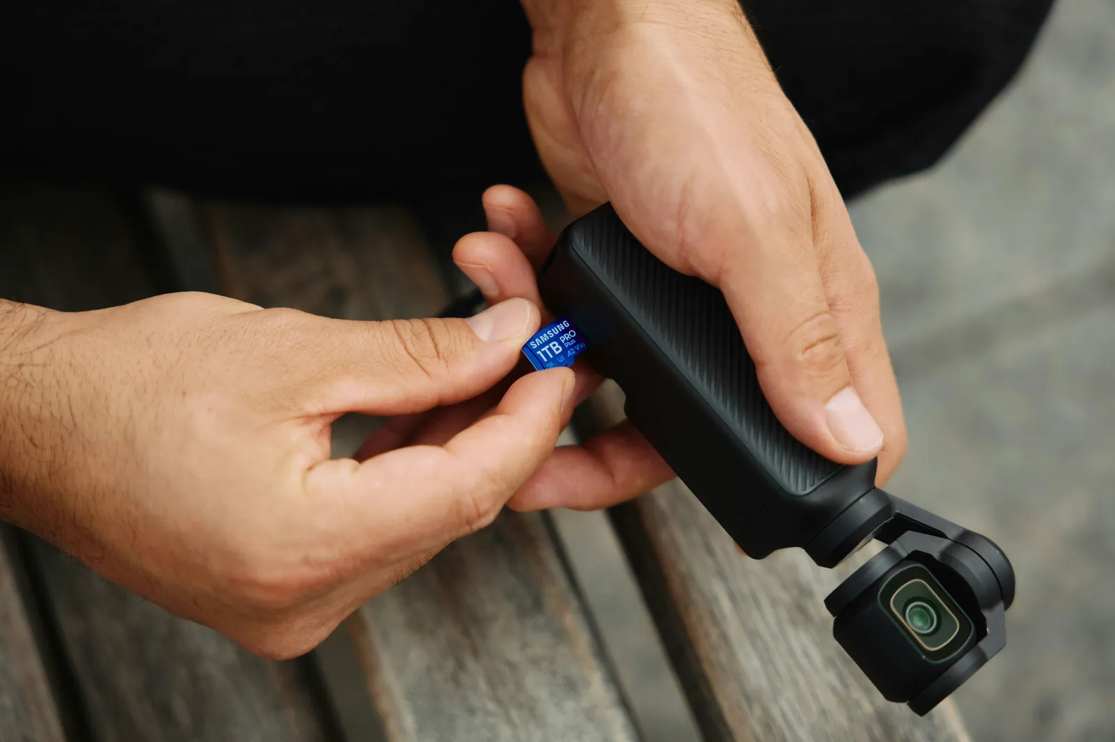 Person handling a camera and memory card representing preserved accident evidence