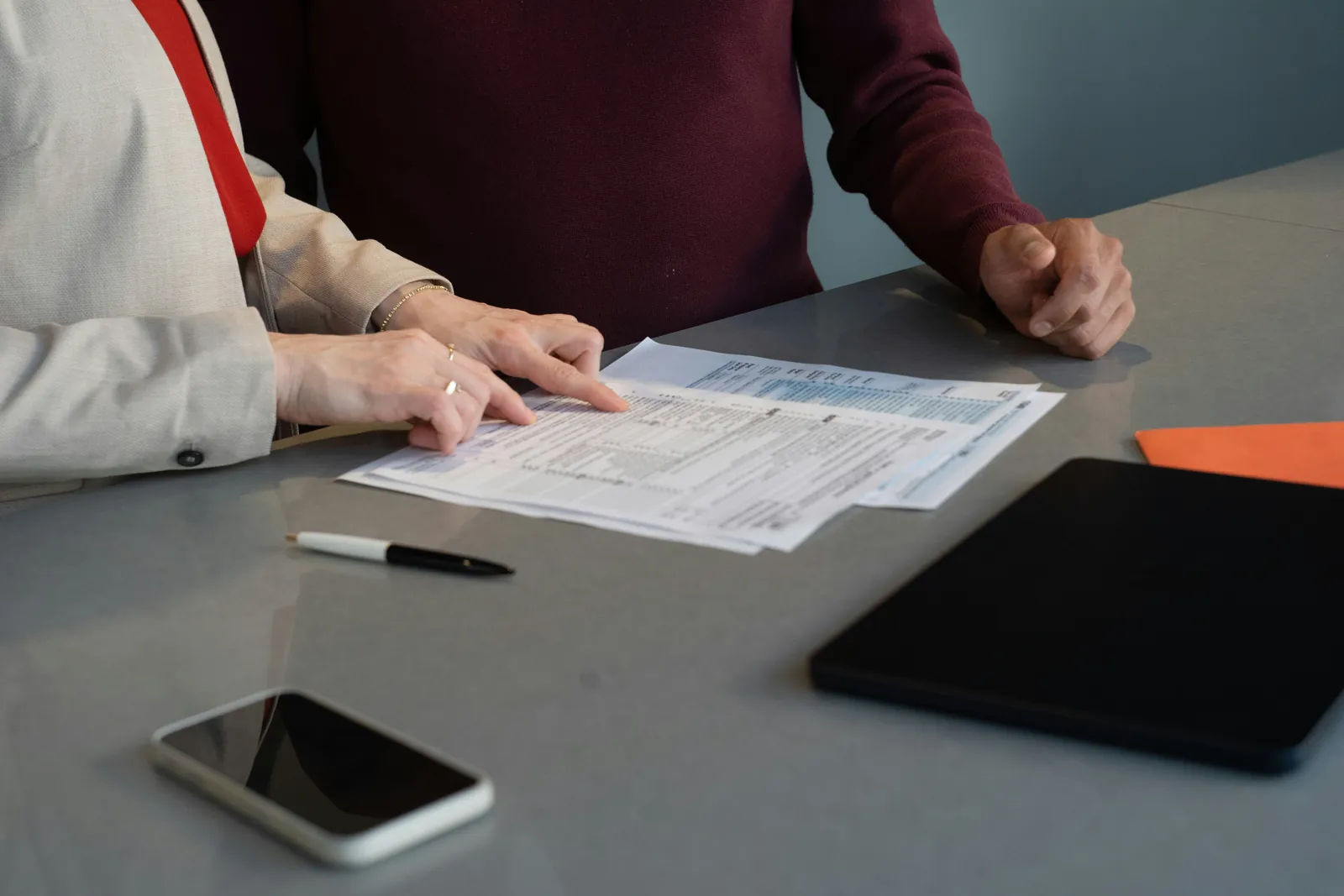 Two people reviewing documents as part of a negligence investigation
